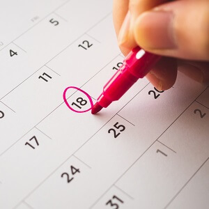 Stock image of someone circling a date on a calendar
