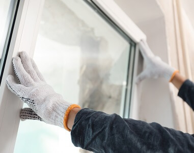 Stock image of someone installing a window