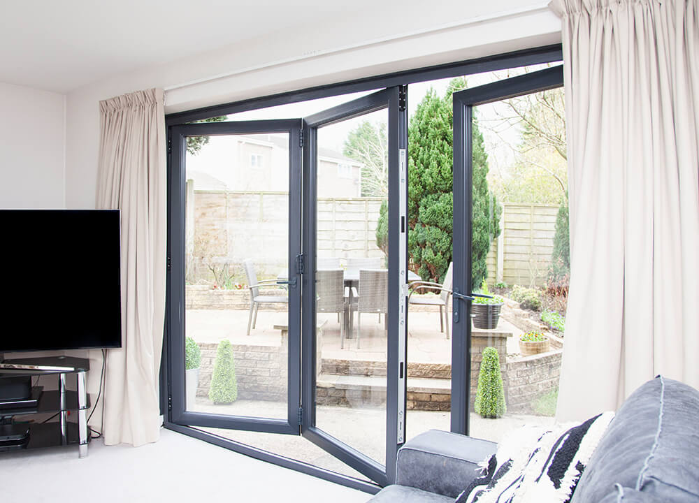 Black bi-fold door partially opened